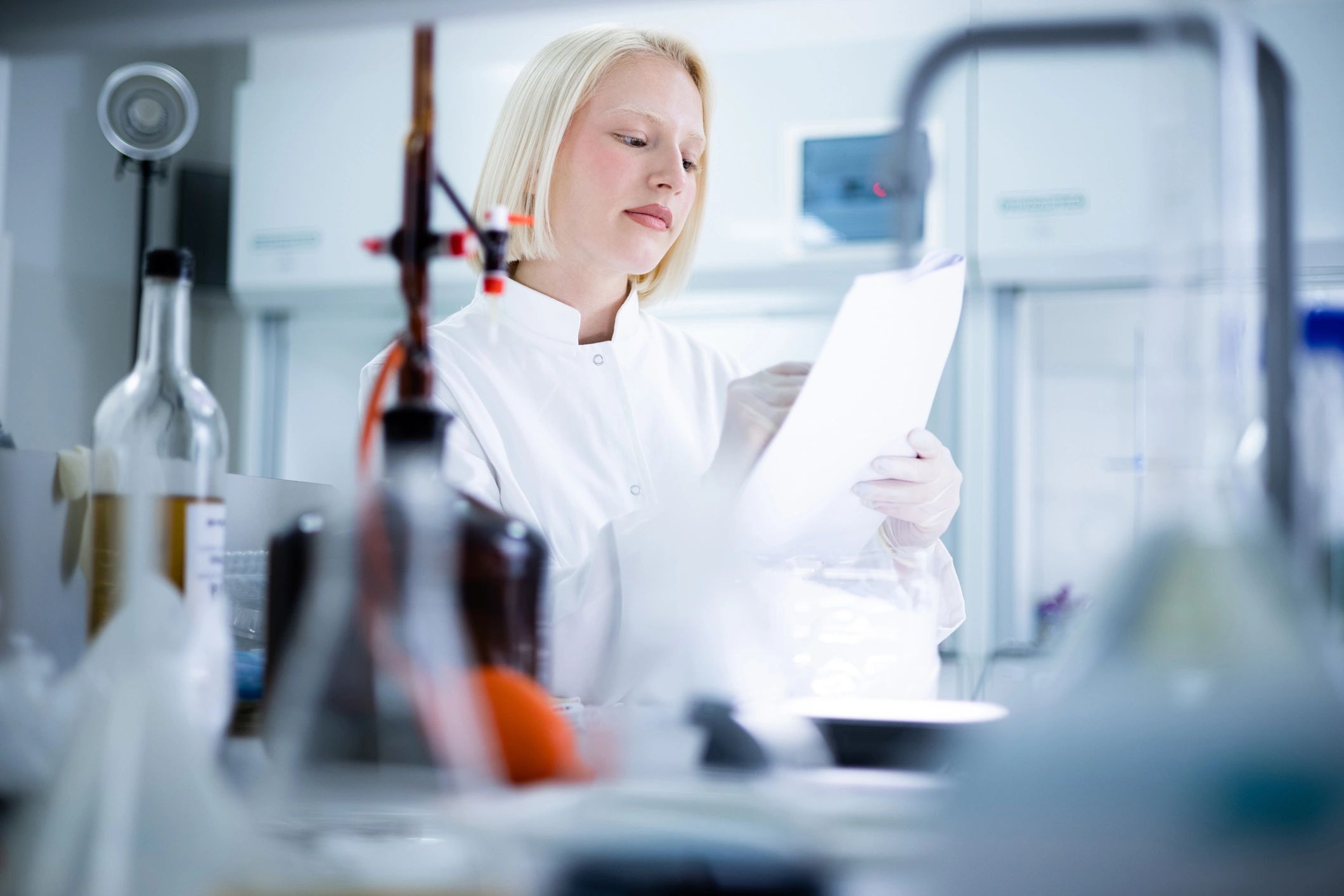 Scientist reviewing documents in a laboratory setting